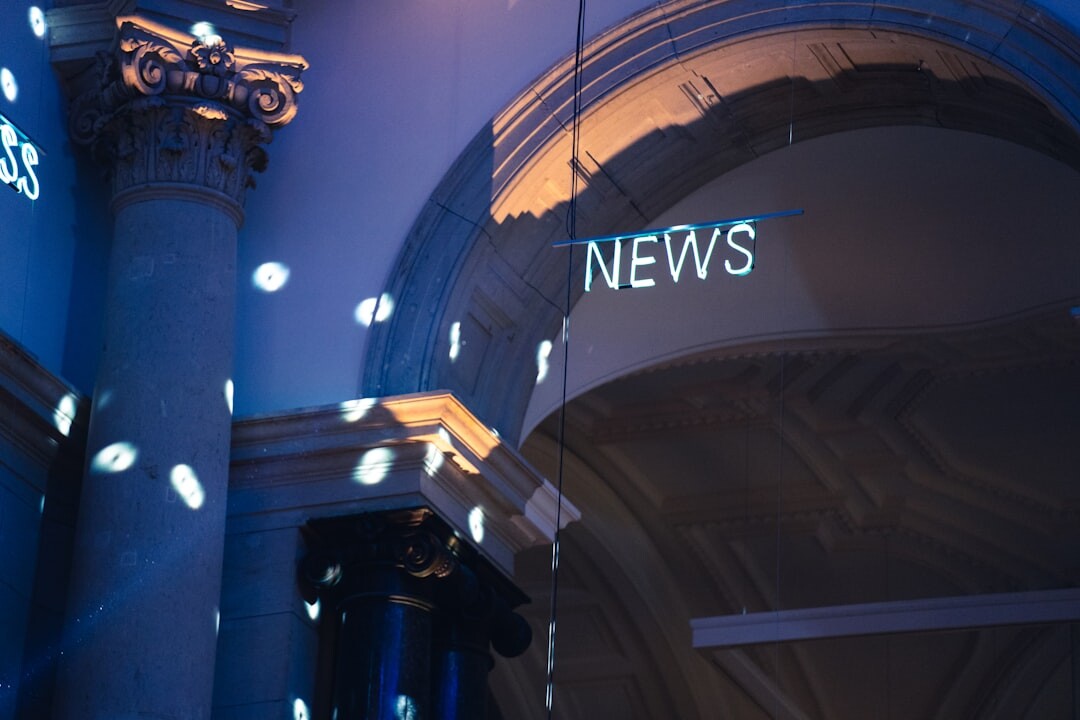 Modern Australian newsroom with multiple screens and reporters working at press desks